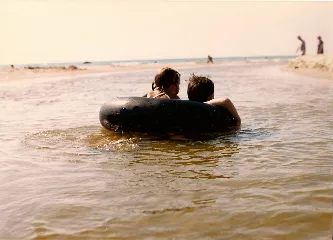 Christina and Peter and their inner tube drift toward Lake Michigan.