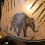 Mica shade with an elephant and other African animals by Lynn Duncan. Photo by BF Newhall.