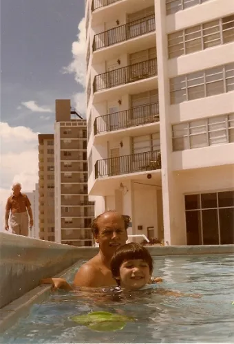 Father and 4-year-old son in a condominium swimming pool not designed for children in Miami Beach in 1985 with Atlantic in the background. Photo by Barbara Newhall