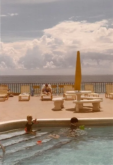 Two children play on the steps of a condominium pool in Miami Beach in 1985 with Atlantic in the background. Photo by Barbara Newhall