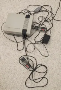 The original 1985 Nintendo Entertainment System console with controllers and wires. Photo by BF Newhall