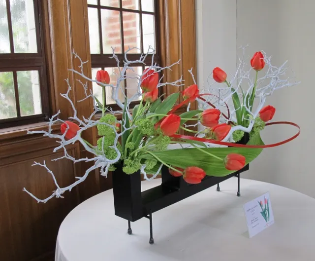 Floral arrangement with red tulips and grey branches. Photo by Barbara Falconer Newhall