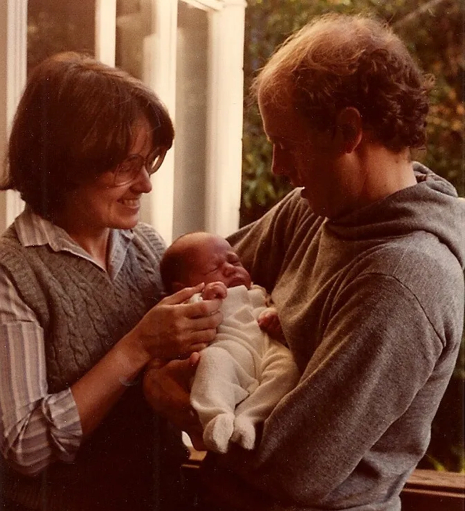 A newborn baby, a few weeks old, is held by his adoring parents. Barbara Newhall Photo