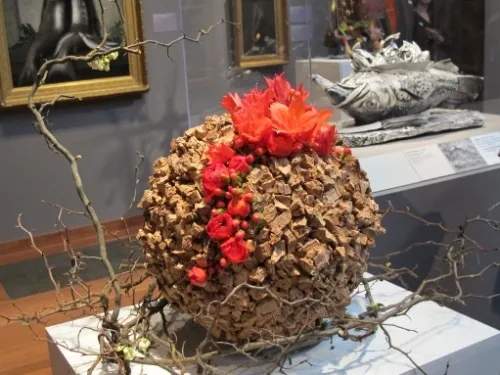 From Poppy's Petalworks, Laura Auyeung & Wilson Auyeung of San Leandro created a bouquet of cork bursting with red blossoms and berries. At the de Young. Photo by BF Newhall