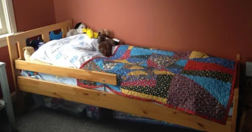 A crazy quilt made by Barbara Falconer Newhall with the help of Sue Mary Fox now lies on a little girl's bed in her grandparents house. Photo by B. Falconer