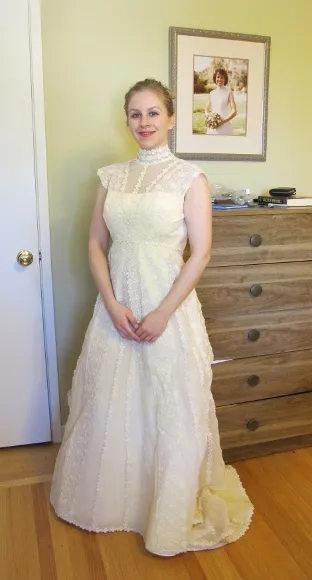 Bride posing in her future mother-in-law's wedding dress. Photo by BF Newhall