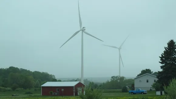 Wind turbine at Lake Winds, Mason County Michigan, with red shed, house and truck. Photo by BF Newhall